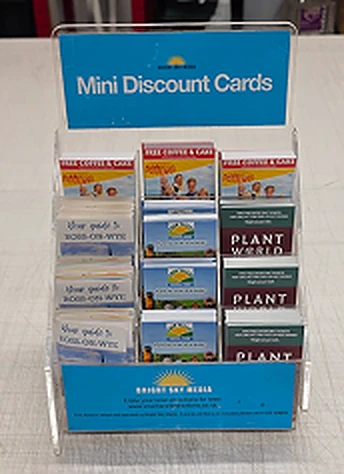 A Bright Sky Media Mini Discount Cards stand, filled with cards from local businesses